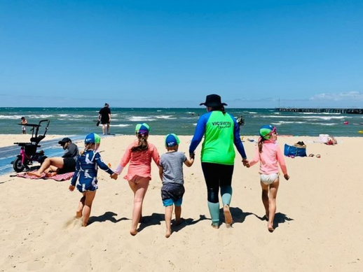 VICSWIM Teacher and Children walking on the beach